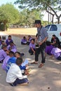 Asian teacher is teaching the music note for student group.